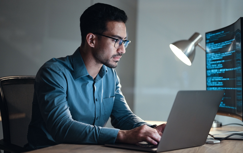 A Man looking at a laptop